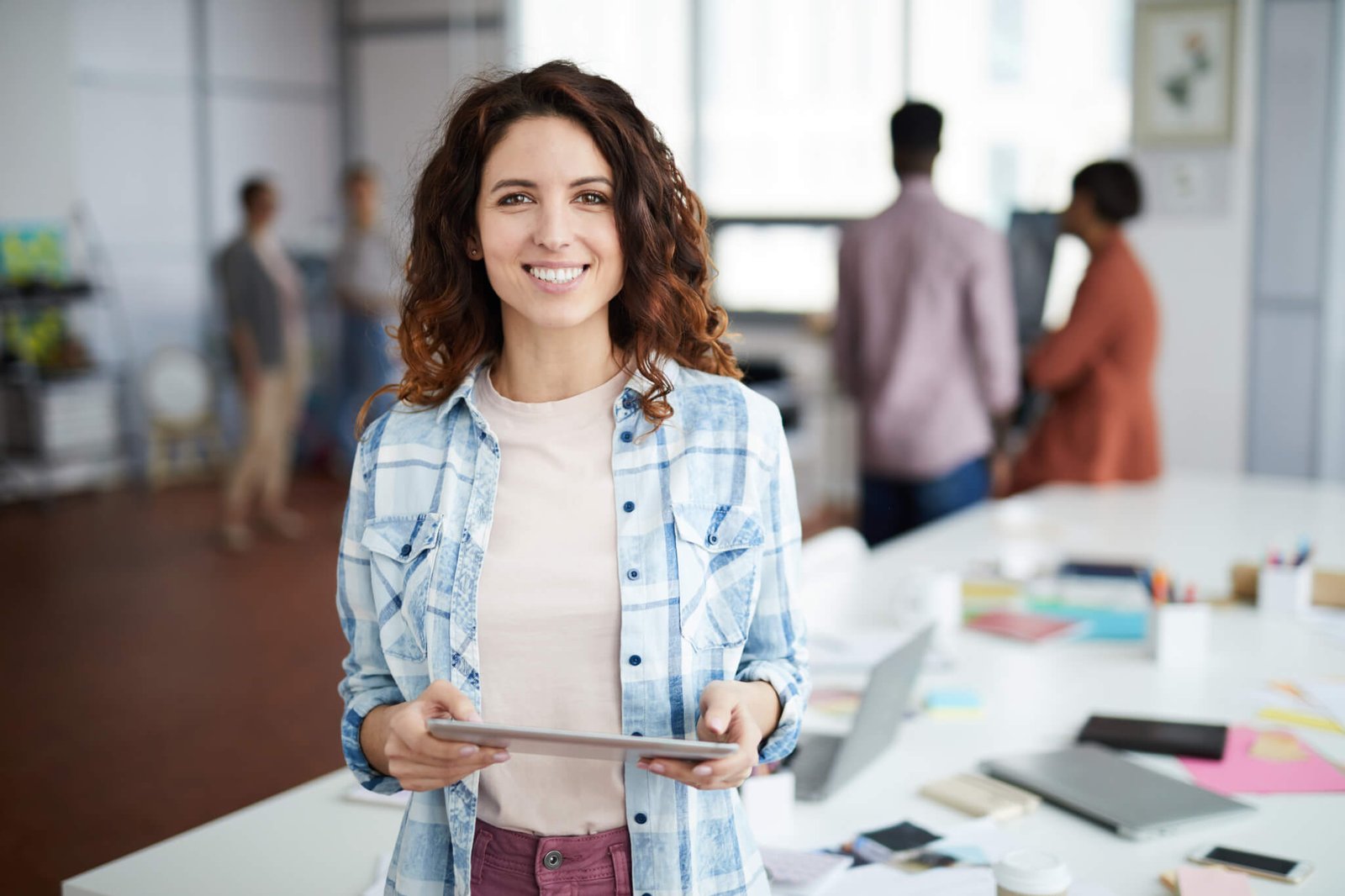 cheerful-young-woman-posing-in-creative-agency.jpg
